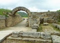 The stone archway leading to the historic stadium of the Ancient Olympia, archaeological site in Peloponnese, Greece Royalty Free Stock Photo