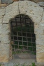 Stone archway and rustic metal gate representing dungeon entrance