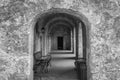 Stone archways leading into walkway in black and white