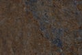 Stone background of rusty color from a single piece. Beautiful textured weathered stone background. Concept stone
