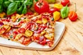 Stone baked sliced pizza with chicken and vegetables