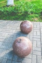 Stone balls on a city street. City square design. Metal hooks on the balls