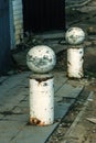 Stone balls on a city street. Urban design fencing road. Large outdoor decorative large cracks from natural granite spheres.