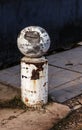 Stone balls on a city street. Urban design fencing road. Large outdoor decorative large cracks from natural granite spheres.