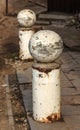 Stone balls on a city street. Urban design fencing road. Large outdoor decorative large cracks from natural granite spheres.