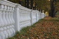 Stone balustrade long row on the colorful background of the autumn Park. Royalty Free Stock Photo