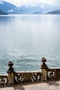 Stone balustrade with vases on the embankment of Lake Como. Villa Monastero, Italy Royalty Free Stock Photo