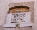 Stone bas-relief of the Venetian lion on one of the houses of Canegliano. The lion of St. Mark is a symbol of the city Royalty Free Stock Photo