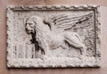 Stone bas-relief of the Venetian lion on one of the houses of Venice. The lion of St. Mark is a symbol of the city of Royalty Free Stock Photo