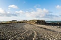 Stony beach with tyre tracks in the stones