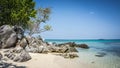 Stone in the beach with sand and water blue with green tree on the side in karimun jawa island Royalty Free Stock Photo