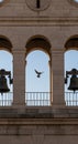 Stone bell tower featuring three arches, flanked by metal bells on either side. The Royalty Free Stock Photo