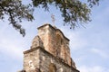 The stone Bell Tower of Mission Espada framed by tree branches, San Antonio, Texas Royalty Free Stock Photo