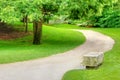 Stone bench on a gravel path Royalty Free Stock Photo