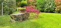 Stone bench in a ornamental garden Royalty Free Stock Photo