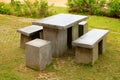 Stone benches table and stool at a garden in Phetchabun, Thailand.