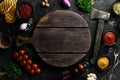 Stone black cooking background. Kitchen board with vegetables and spices. On a black stone background. Royalty Free Stock Photo