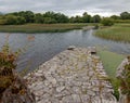 Stone boat dock of ancient castle ruins McCarthy Mor on Lake Lough Leane at Killarney on the Ring of Kerry in Ireland