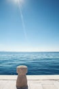 Stone bollard on boat dock and sea Royalty Free Stock Photo