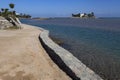 Stone border on the sea and the island.