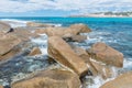 Stone boulders in the foamy waves of the azure ocean, Salmon Beach, Esperance, Western Australia