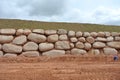 Stone boulders are stacked on the ground and used as retaining walls.