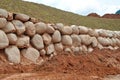 Stone boulders are stacked on the ground and used as retaining walls.