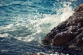 Stone breakwater with breaking waves.