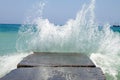 Stone breakwater with breaking waves.