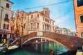 Stone brick bridge Ponte Caneva across Vena water canal in historical centre of Chioggia