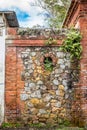 Stone and brick wall between to abandond structures Royalty Free Stock Photo