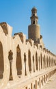 Stone bricks old decorated fence of Mosque of Ibn Tulun and minaret of the mosque, Cairo, Egypt Royalty Free Stock Photo