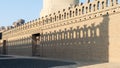 Stone bricks old decorated fence with wooden door and shadows of decorations of the opposite fence, Mosque of Ibn Tulun Royalty Free Stock Photo