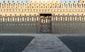 Stone bricks old decorated fence with wooden door and shadows of decorations of the opposite fence, Mosque of Ibn Tulun Royalty Free Stock Photo