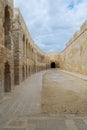 Stone bricks wall with embedded recessed arches at an old abandoned horse stall at the Citadel of Qaitbay, Alexandria, Egypt Royalty Free Stock Photo