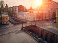 Stone Bridge in historical center of Voronezh at sunset. Old buildings and road intersection in European city downtown