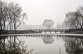 A Stone Bridge on the Ice Lake in Fog Day Royalty Free Stock Photo