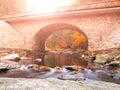 Stone bridge over River Divoka Orlice at Zemska brana, Orlicke hory, or Eagle Mountains, Czech Republic. Autumn time