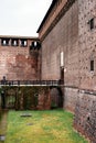 Stone bridge with railings near the wall of the Castello Sforzesco. Milan, Italy Royalty Free Stock Photo