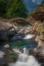 a stone bridge under which flows a stream Royalty Free Stock Photo
