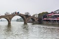 Stone bridge and wooden historic buildings at the bank of canal in Zhujiajiao in a rainy day, an ancient water town in Shanghai,