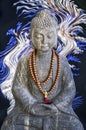 Stone Buddha statue, blue and white lights Royalty Free Stock Photo