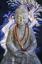 Stone Buddha statue, blue and white lights