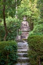 Stone Buddha statue in the forest garden of Ryoan-ji temple. Kyoto. Japan