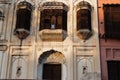 Stone building an arched doorway and a balcony adorned with intricate stonework, Islamabad