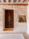 Stone building entrance with a potted plant. Organic Farm, Ibiza, Spain Royalty Free Stock Photo