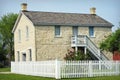 Stone Building with White Picket Fence Royalty Free Stock Photo