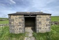 Stone bus shelter, surrounded by plants, dry stone walls, and fields in, Horton in Ribblesdale, UK Royalty Free Stock Photo