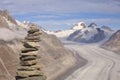 Stone cairn and Aletsch Glacier in Switzerland