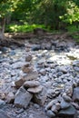 Stone cairn in forest river bed Royalty Free Stock Photo